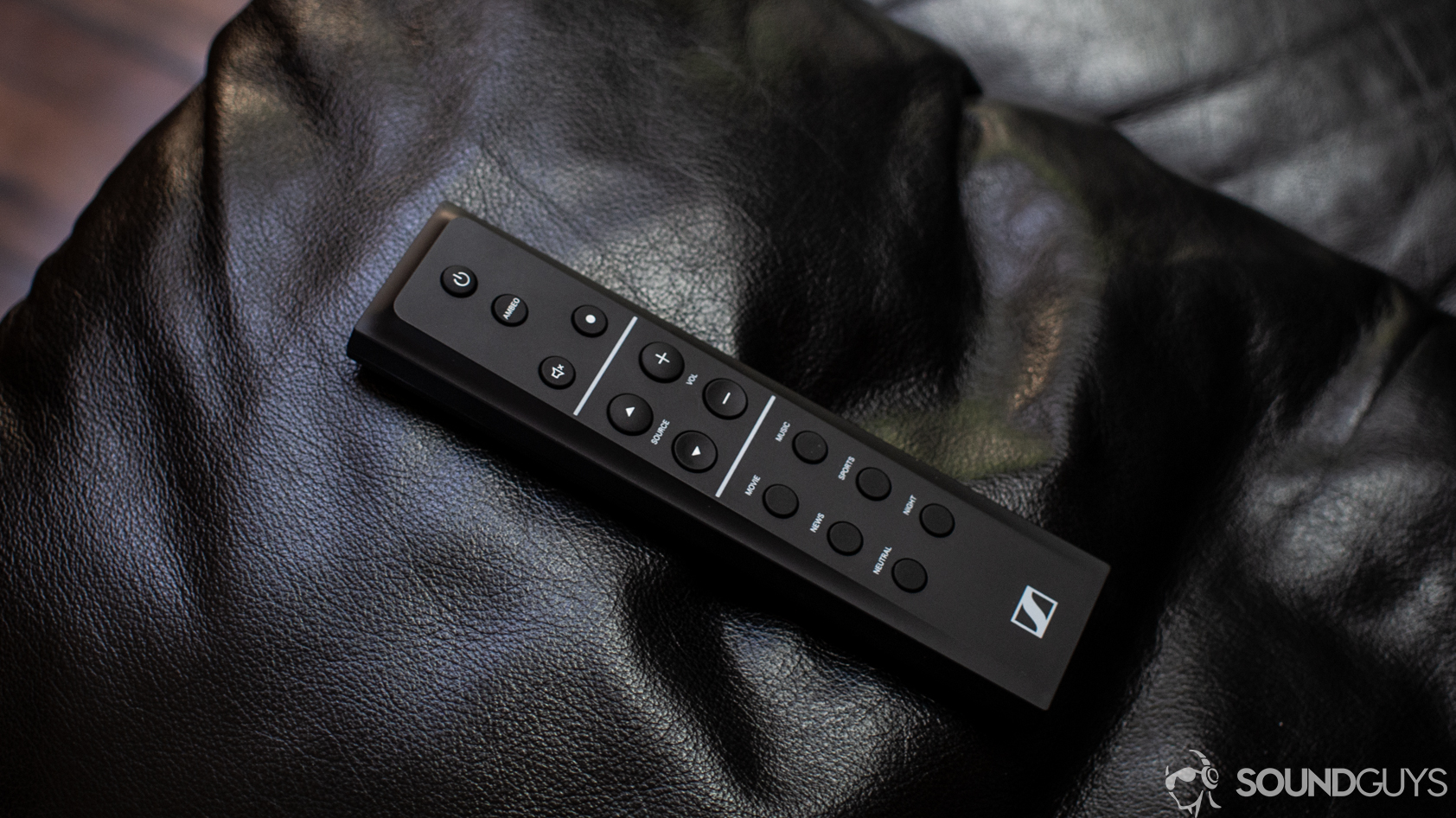 sennheiser-ambeo-soundbar-remote A photo of the Sennheiser Ambeo Soundbar's remote on a leather couch arm.