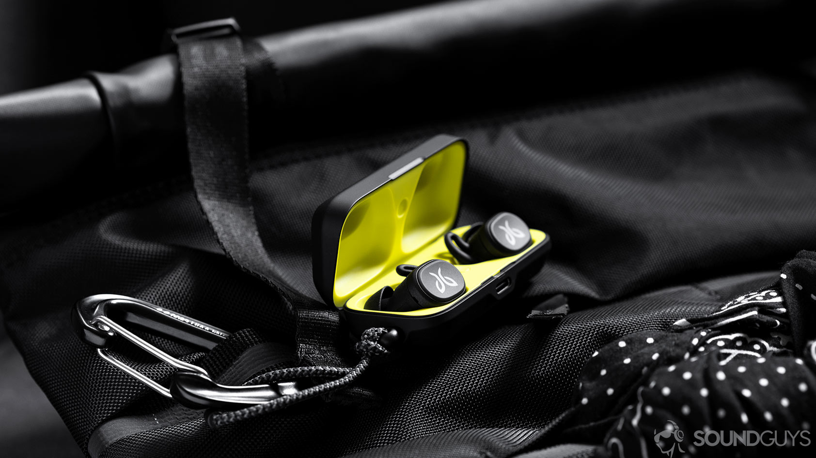 Jaybird Vista-1_earbuds charging case backpack An image of the Jaybird Vista earbuds in charging case which is open and on a Chrome backpack.