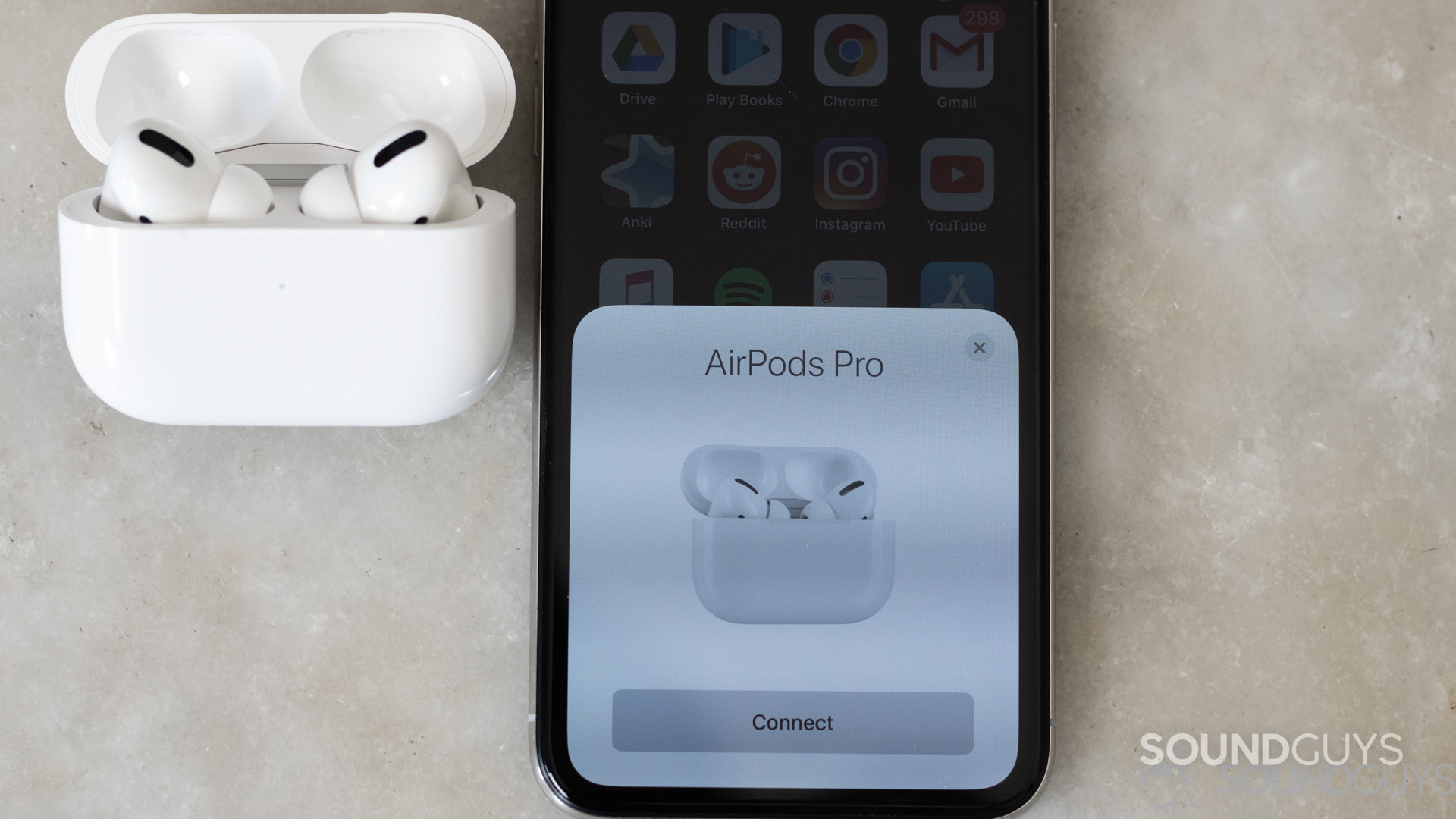 Apple AirPods Pro-9 Shot of the open AirPods Pro case along with the pop-up connecting card on an iPhone X