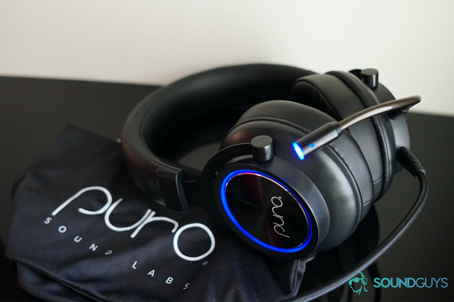 PuroGamer OOB The Puro Sound Labs PuroGamer headset sits on top of its carry bag on a black surface, shown to address the question can headphones cause tinnitus.