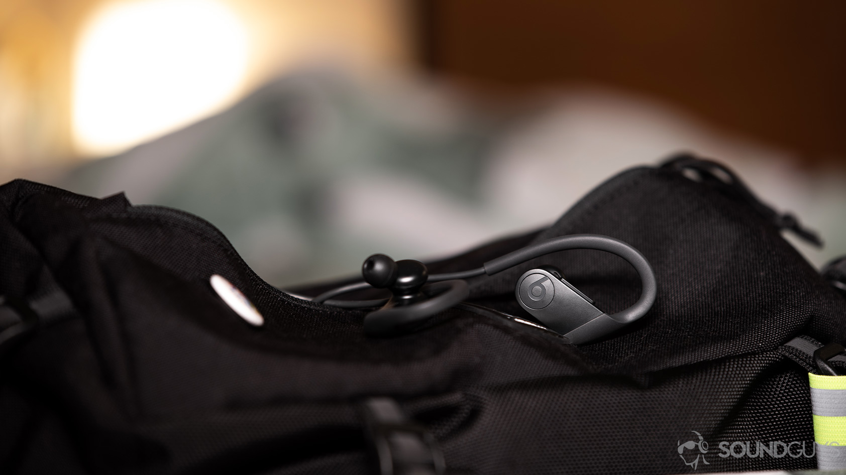 Beats Powerbeats-wireless workout earbuds backpack A picture of the Apple Beats Powerbeats workout earbuds on top of a nylon sling bag.