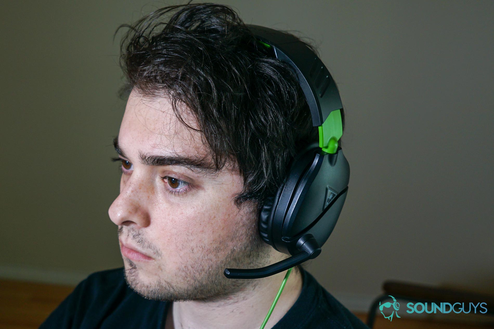 Turtle Beach Recon 70 gaming headset man wears A man wears The Turtle Beach Recon 70 gaming headset sitting at a PC.