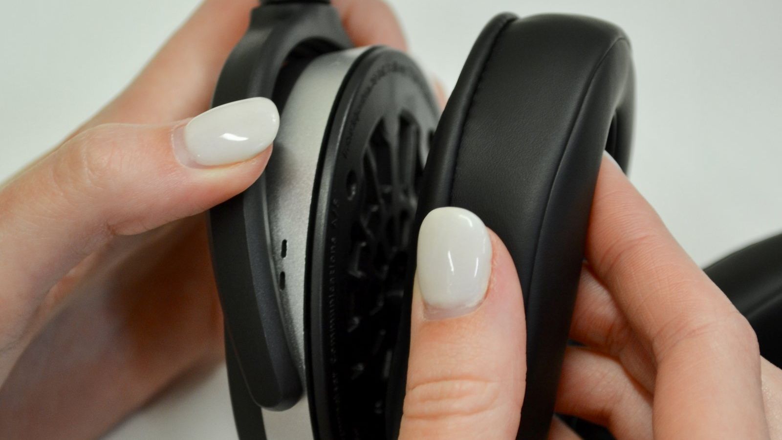 Replacing Headphones Ear Pads Woman removing ear pad from a pair of Sennheiser headphones.