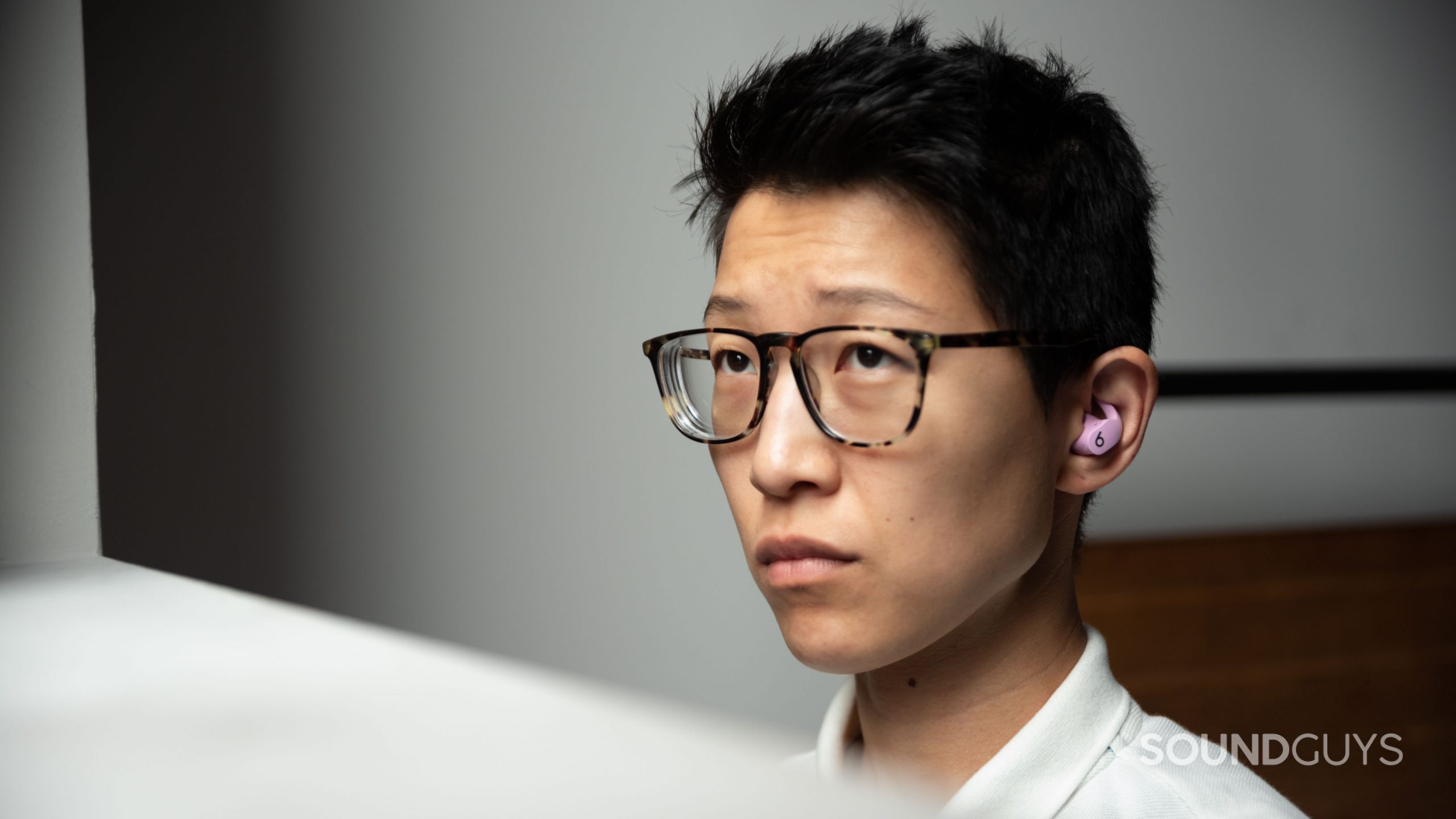 Beats Fit Pro noise canceling true wireless earbuds woman wears A woman wears the Beats Fit Pro noise canceling true wireless earbuds in purple.