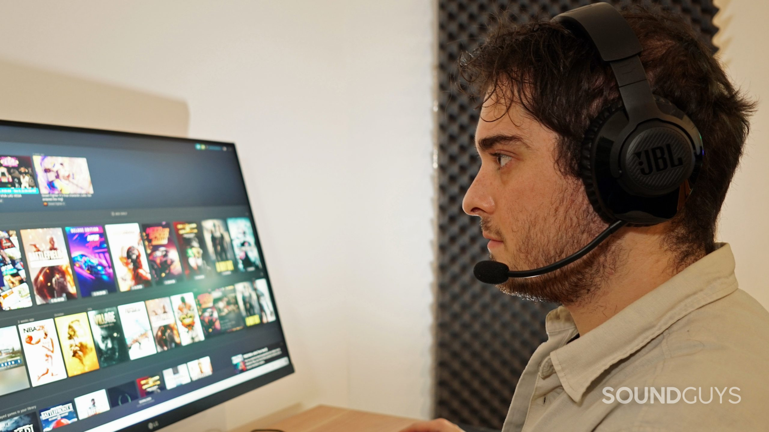 JBL-Quantum-350-headshot JBL Quantum 350 Wireless on a man's head while he is looking at a desktop monitor running Steam with games like Resident Evil 7 and Battlefield 1 on it.