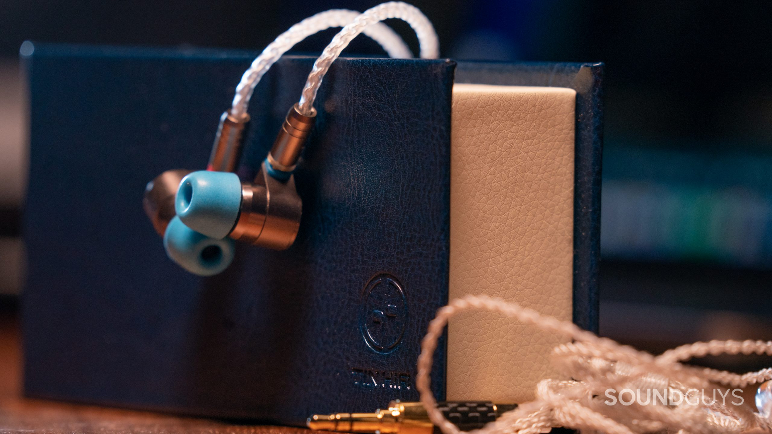 TIN HiFi T2-hanging Dangling over the box to demonstrate the bendable cable is the the Linsoul TIN Audio T2.