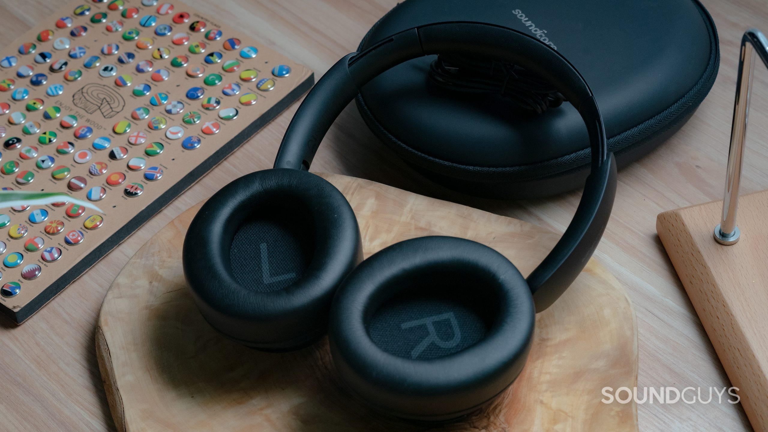 Anker Soundcore Space Q45 wooden table showing ear cups The Anker Soundcore Space Q45 sitting on a wooden table with the case in the background, the interior of the ear cups are facing the user.